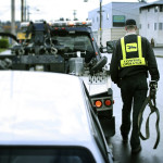 Tow truck driver preparing to tow vehicle