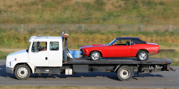 Tow truck company offering vehicle transport to car shows and car auctions.